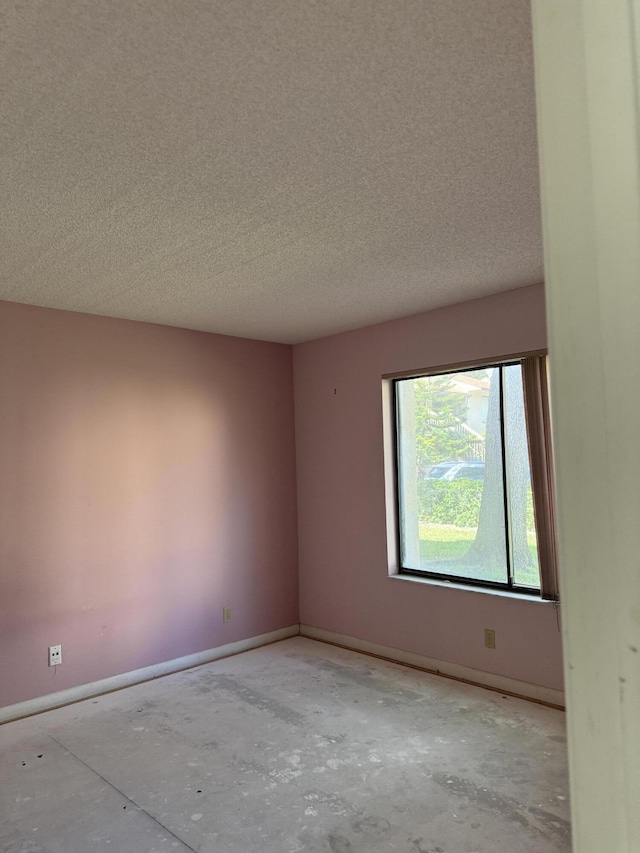 21950 Soundview Ter Unit 107, Boca Raton, FL 33433 - empty room featuring a textured ceiling and baseboards