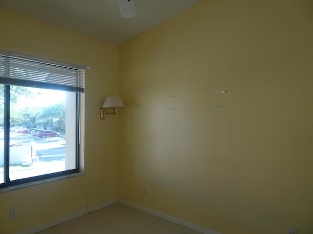 21950 Soundview Ter Unit 107, Boca Raton, FL 33433 - empty room with healthy amount of natural light, ceiling fan, and light tile patterned flooring