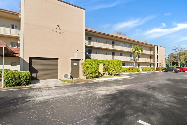 7750 NW 50th St Unit 106, Lauderhill, FL 33351 - view of apartment building / complex featuring uncovered parking