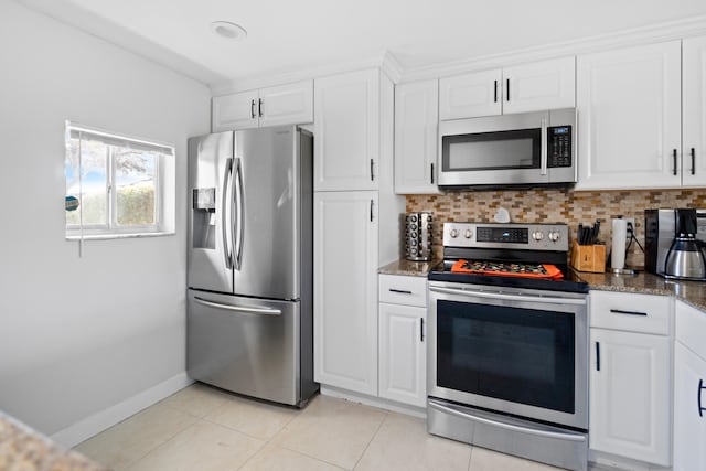 7750 NW 50th St Unit 106, Lauderhill, FL 33351 - kitchen with appliances with stainless steel finishes, white cabinets, tasteful backsplash, and dark stone counters