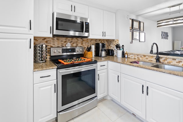 7750 NW 50th St Unit 106, Lauderhill, FL 33351 - kitchen with appliances with stainless steel finishes, tasteful backsplash, light tile patterned flooring, and light stone countertops
