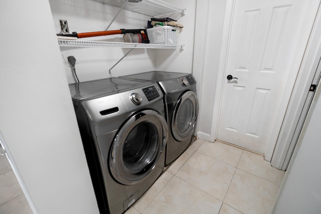 7750 NW 50th St Unit 106, Lauderhill, FL 33351 - washroom with washing machine and clothes dryer and light tile patterned floors