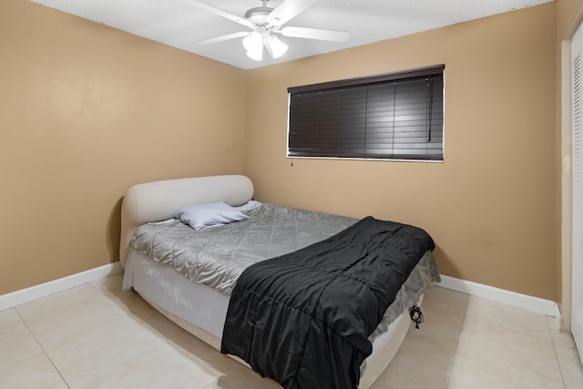 7750 NW 50th St Unit 106, Lauderhill, FL 33351 - tiled bedroom featuring baseboards and a ceiling fan