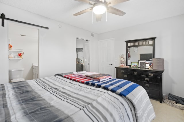 7750 NW 50th St Unit 106, Lauderhill, FL 33351 - bedroom featuring a barn door, a ceiling fan, and light tile patterned floors