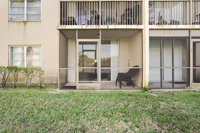7750 NW 50th St Unit 106, Lauderhill, FL 33351 - back of property featuring stucco siding and a lawn