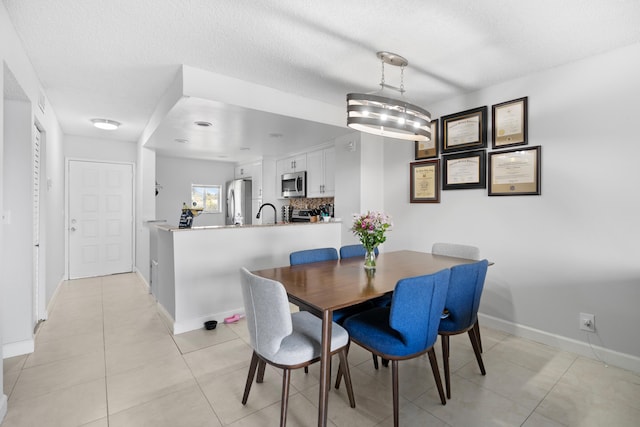 7750 NW 50th St Unit 106, Lauderhill, FL 33351 - dining area with baseboards and light tile patterned floors