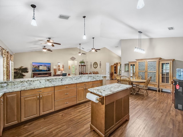 5301 Bald Cypress Trl, Fort Pierce, FL 34951 - kitchen with ceiling fan, lofted ceiling, dark wood-style floors, pendant lighting, and a center island