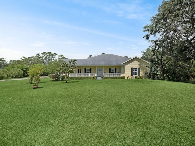 5301 Bald Cypress Trl, Fort Pierce, FL 34951 - view of front of house with a front yard and covered porch