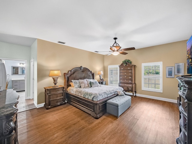 5301 Bald Cypress Trl, Fort Pierce, FL 34951 - bedroom with wood finished floors, a ceiling fan, and ensuite bath