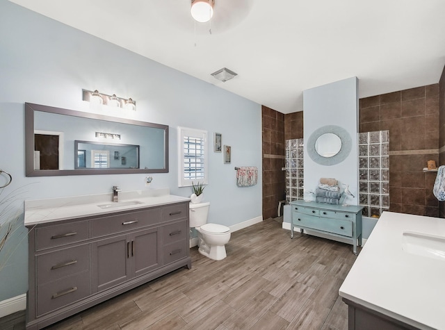 5301 Bald Cypress Trl, Fort Pierce, FL 34951 - bathroom featuring vanity, a walk in shower, wood finished floors, and ceiling fan