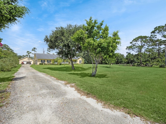 5301 Bald Cypress Trl, Fort Pierce, FL 34951 - view of front of home with a front yard and a garage