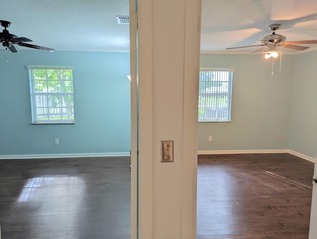 3074 SE Dalhart Rd, Port Saint Lucie, FL 34952 - spare room featuring ceiling fan, dark wood finished floors, and crown molding