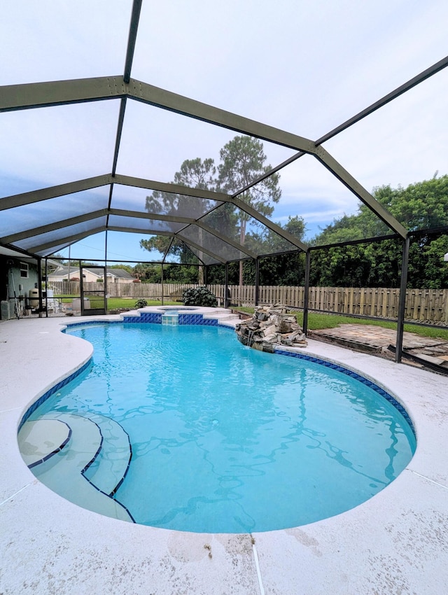 3074 SE Dalhart Rd, Port Saint Lucie, FL 34952 - view of pool featuring a fenced backyard, glass enclosure, a patio, and a pool with connected hot tub