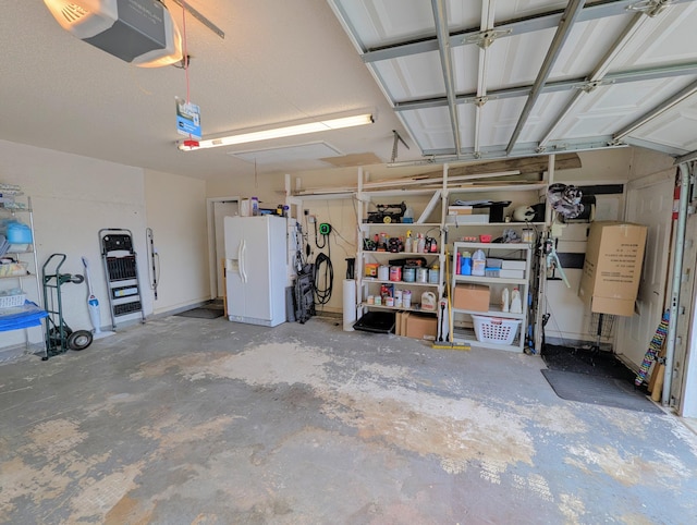 3074 SE Dalhart Rd, Port Saint Lucie, FL 34952 - garage with white refrigerator with ice dispenser and a garage door opener