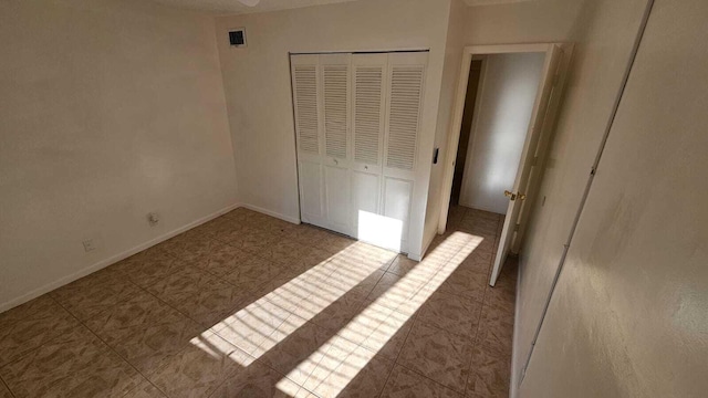 206 Foxtail Dr Unit D1, Greenacres, FL 33415 - unfurnished bedroom featuring a closet and tile patterned flooring