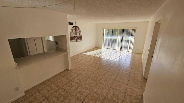206 Foxtail Dr Unit D1, Greenacres, FL 33415 - tiled empty room featuring a textured ceiling