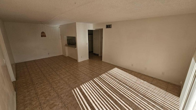 206 Foxtail Dr Unit D1, Greenacres, FL 33415 - empty room with a textured ceiling and tile patterned floors