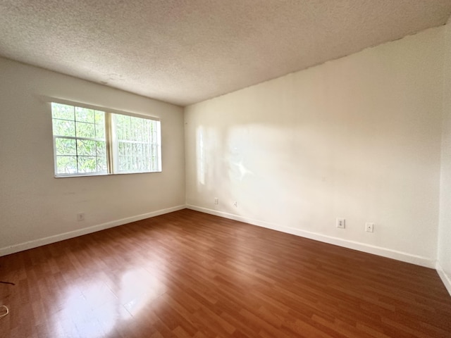 751 Cypress Ln Unit K, Deerfield Beach, FL 33064 - spare room with dark wood-style flooring and a textured ceiling