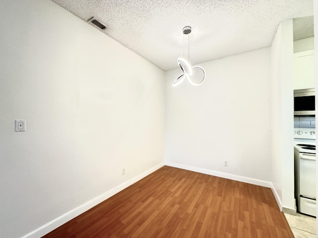 751 Cypress Ln Unit K, Deerfield Beach, FL 33064 - unfurnished dining area featuring wood finished floors and a textured ceiling