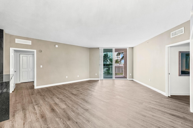 350 N Federal Hwy Unit 609, Boynton Beach, FL 33435 - unfurnished living room featuring wood finished floors