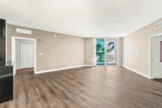 350 N Federal Hwy Unit 609, Boynton Beach, FL 33435 - unfurnished living room with wood finished floors, stairs, and a wall of windows