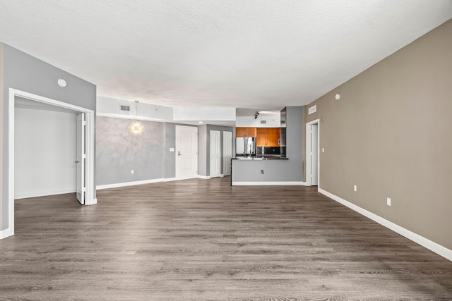 350 N Federal Hwy Unit 609, Boynton Beach, FL 33435 - unfurnished living room with dark wood-type flooring and a textured ceiling
