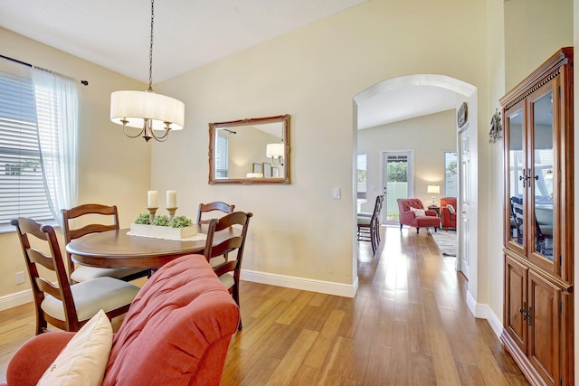 16174 SW 9th St, Pembroke Pines, FL 33027 - dining area featuring arched walkways, light wood-style floors, and a chandelier