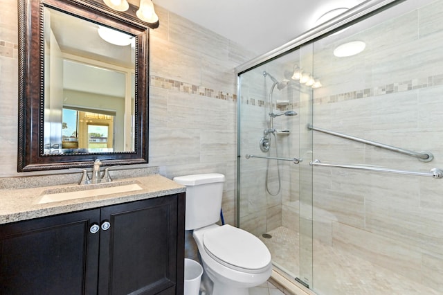 154 Tuscany C, Delray Beach, FL 33446 - bathroom featuring a shower stall, vanity, and tile walls