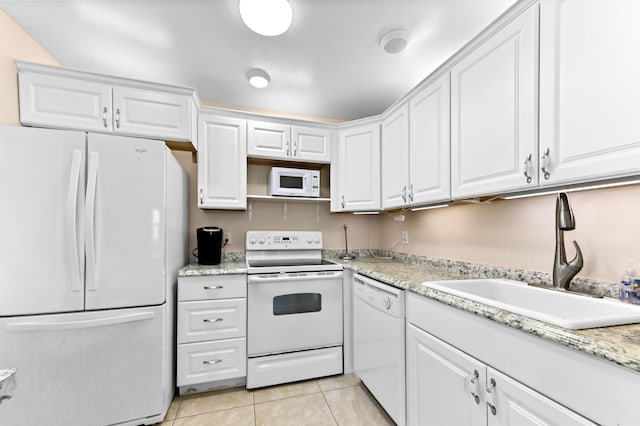 154 Tuscany C, Delray Beach, FL 33446 - kitchen with white appliances, white cabinets, and light tile patterned floors