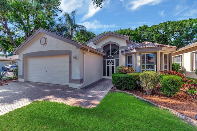 7937 Sonora St, Boynton Beach, FL 33437 - view of front of property featuring stucco siding, an attached garage, decorative driveway, and a front lawn