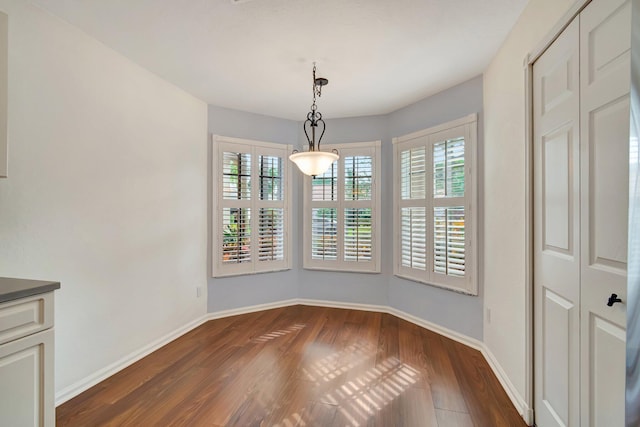 7937 Sonora St, Boynton Beach, FL 33437 - unfurnished dining area with dark wood-style flooring and baseboards