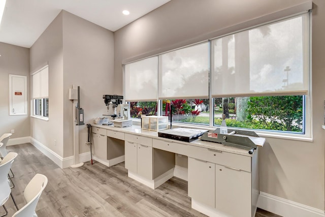 7937 Sonora St, Boynton Beach, FL 33437 - kitchen featuring light countertops, light wood finished floors, white cabinets, recessed lighting, and built in desk