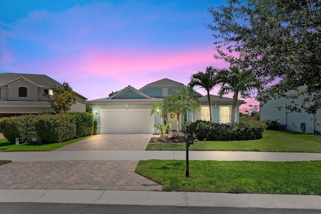 709 SW Sun Cir, Palm City, FL 34990 - ranch-style house featuring driveway, an attached garage, and a lawn
