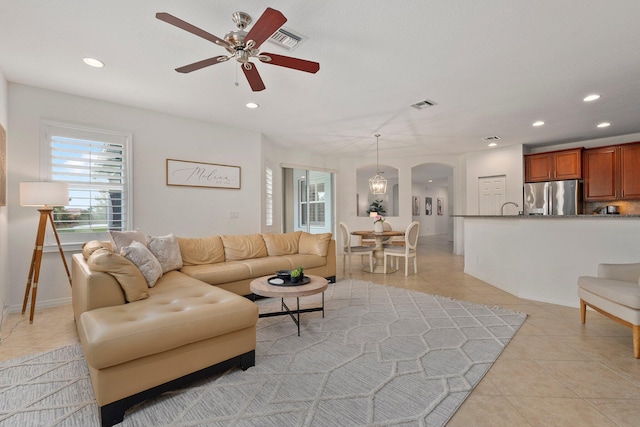 709 SW Sun Cir, Palm City, FL 34990 - living area featuring a ceiling fan, recessed lighting, arched walkways, and light tile patterned floors