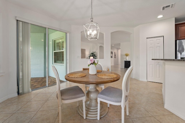 709 SW Sun Cir, Palm City, FL 34990 - dining area featuring arched walkways, light tile patterned floors, and a chandelier