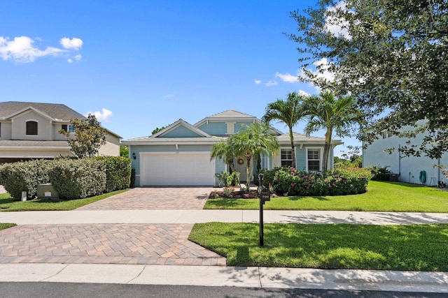 709 SW Sun Cir, Palm City, FL 34990 - view of front facade featuring decorative driveway, a garage, and a front yard
