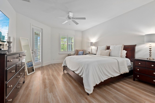 709 SW Sun Cir, Palm City, FL 34990 - bedroom with light wood finished floors, a ceiling fan, and lofted ceiling
