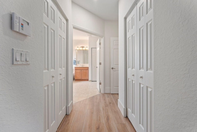 709 SW Sun Cir, Palm City, FL 34990 - hallway featuring a textured wall and light wood finished floors