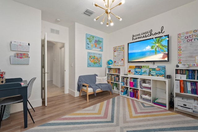 709 SW Sun Cir, Palm City, FL 34990 - playroom featuring a chandelier and wood finished floors