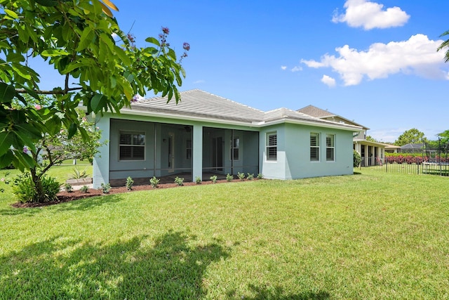 709 SW Sun Cir, Palm City, FL 34990 - rear view of house with a sunroom, stucco siding, and a tile roof