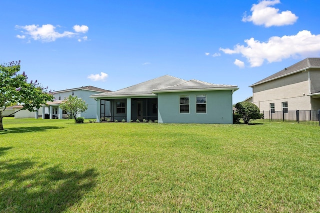 709 SW Sun Cir, Palm City, FL 34990 - rear view of house with stucco siding, a sunroom, and a tile roof