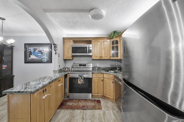 512 Shady Pine Way Unit B1, Greenacres, FL 33415 - kitchen with stainless steel appliances, a peninsula, dark stone countertops, glass insert cabinets, and crown molding