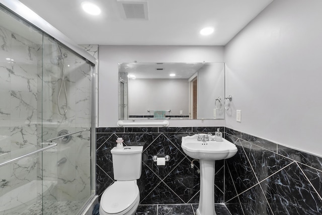 512 Shady Pine Way Unit B1, Greenacres, FL 33415 - bathroom featuring a marble finish shower, tile walls, wainscoting, marble finish flooring, and recessed lighting