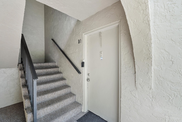 512 Shady Pine Way Unit B1, Greenacres, FL 33415 - stairs featuring carpet flooring and a textured wall