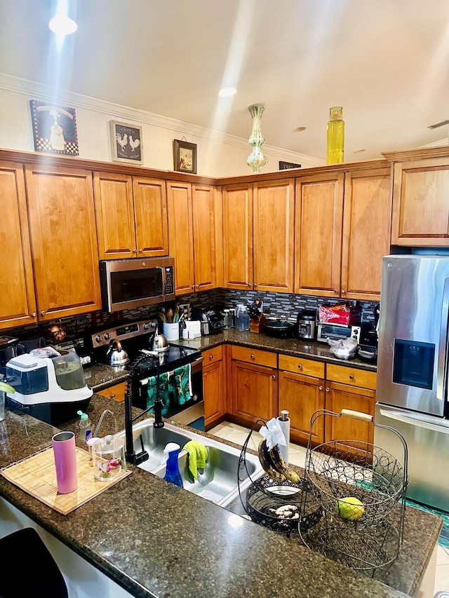 5200 Rising Comet Ln, Greenacres, FL 33463 - kitchen featuring appliances with stainless steel finishes, crown molding, brown cabinetry, and backsplash
