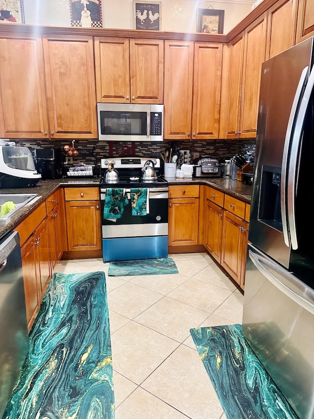 5200 Rising Comet Ln, Greenacres, FL 33463 - kitchen with appliances with stainless steel finishes, decorative backsplash, brown cabinets, and light tile patterned floors