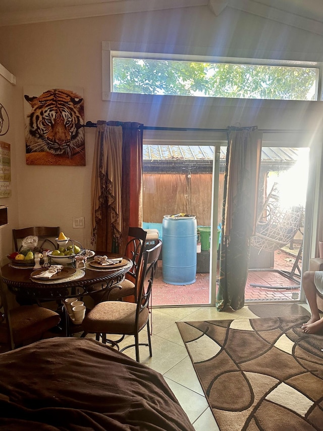 5200 Rising Comet Ln, Greenacres, FL 33463 - dining area featuring plenty of natural light, tile patterned floors, ornamental molding, and lofted ceiling