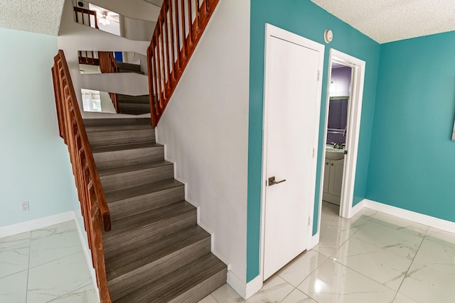 8129 Sedgewick Ct Unit 29-A, Lake Clarke Shores, FL 33406 - stairs featuring marble finish floors and a textured ceiling