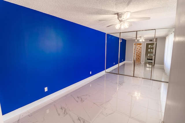 8129 Sedgewick Ct Unit 29-A, Lake Clarke Shores, FL 33406 - unfurnished room with ceiling fan, marble finish floors, and a textured ceiling