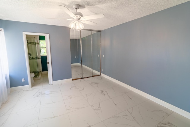 8129 Sedgewick Ct Unit 29-A, Lake Clarke Shores, FL 33406 - unfurnished bedroom with a textured ceiling, marble finish floors, ceiling fan, and a closet
